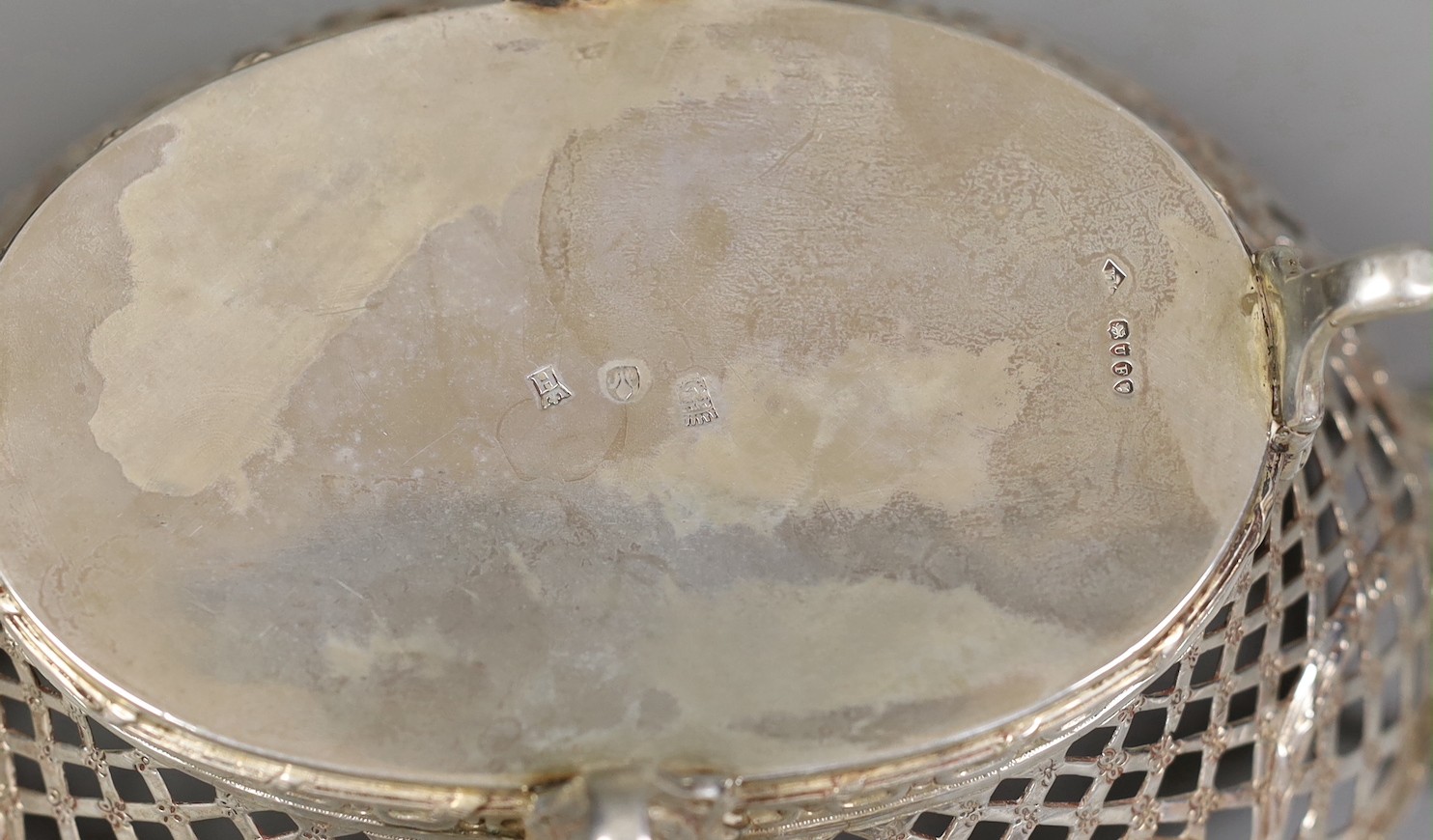 A late Victorian Hanau? pierced silver two handled bowl, embossed with busts, import marks for London, 1895, 25.7cm over handles, 14oz.